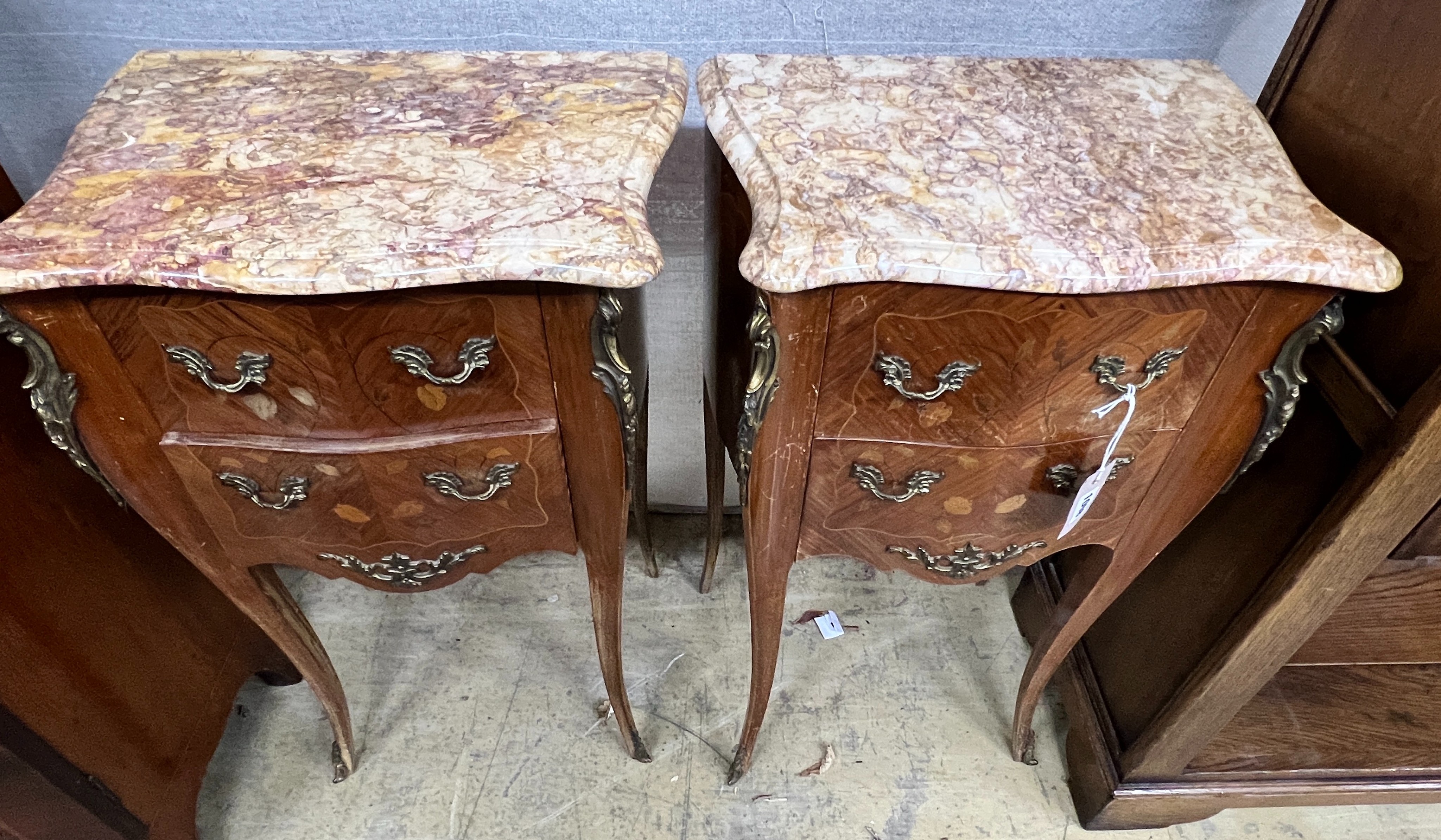 A pair of Louis XVI style inlaid kingwood marble top serpentine bedside chests, width 45cm, depth 31cm, height 73cm